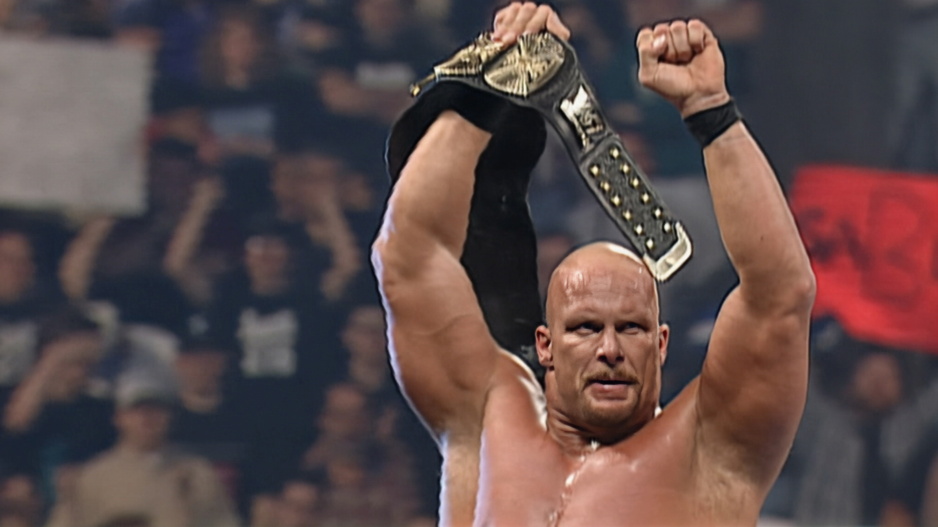 Stone Cold Steve Austin lifting a belt above his head