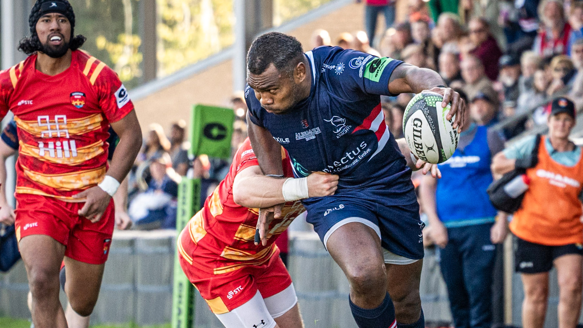 An opposition player attempts to tackle Semesa Rokodugani