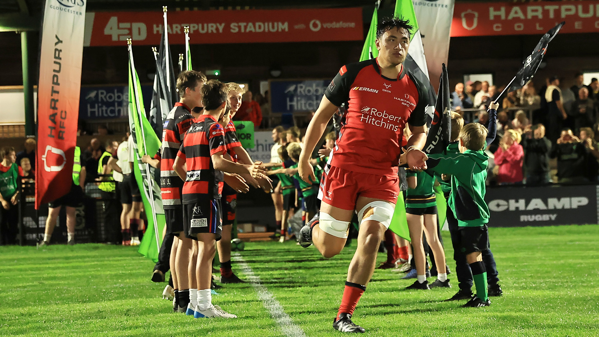 Hartpury players running out from the dressing room at the start of a rugby match