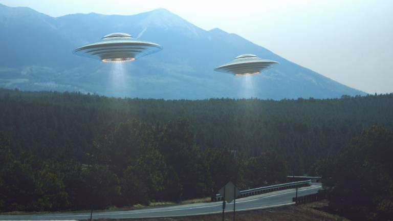 Two UFOs hovering a road