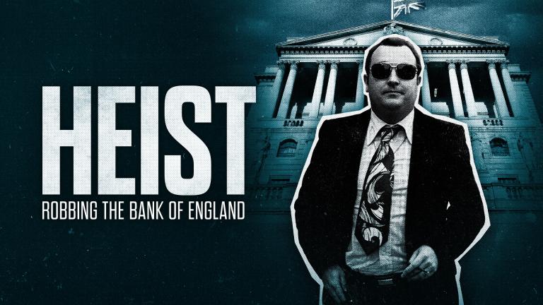 A man in a suit and sunglasses stands in front of the Bank of England. Large text reads “Heist: Robbing the Bank of England.”