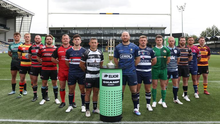 The 12 captains of all Elior Champ Rugby teams line up next to the trophy 