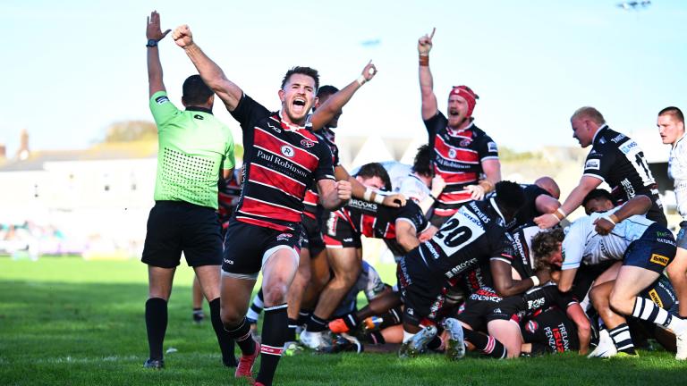 Cornish Pirates players celebrate scoring a try